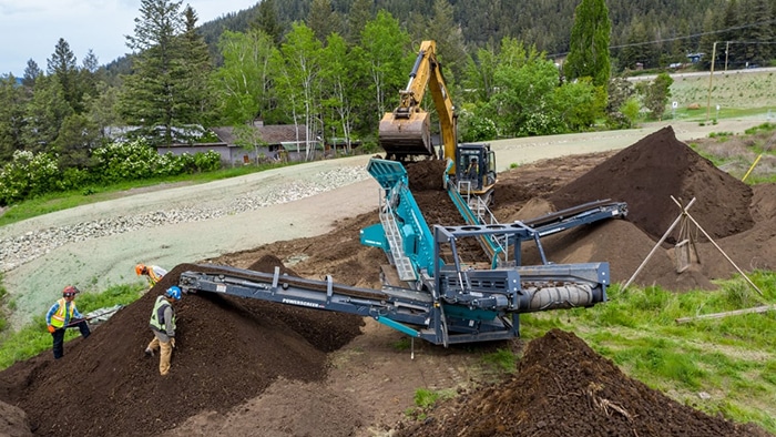 Powerscreen Warrior screening topsoil at archaeological site. 