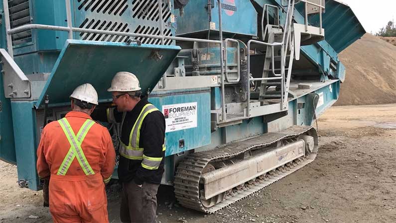 Field Service Technicians Working On. A Powerscreen Crusher