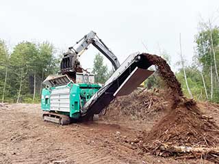 Crambo Shredder at Work shredding Wood ad Green Waste on a Land Clearing Site. 