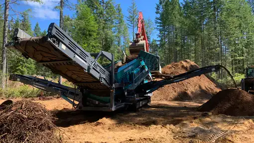 Powescreen Warrior Removing wood and organic matter from top soil.