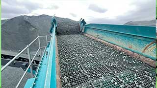 Crushed stone passing over a screen for sizing 