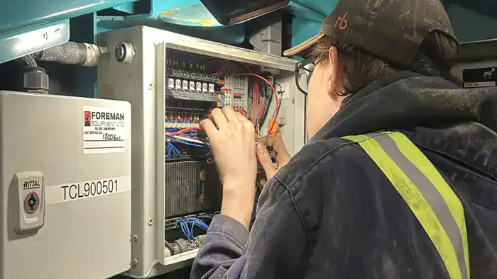 service-tech-inspects-PLC